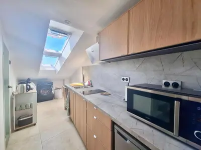 a kitchen with a sink and a stove at Lofty Hideout with 2 bedrooms in Nice