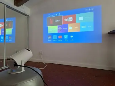 a projector screen in a room with a fan at Lofty Hideout with 2 bedrooms in Nice