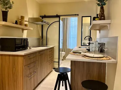 a kitchen with a counter with a microwave and a sink at Le George Ville in Nice
