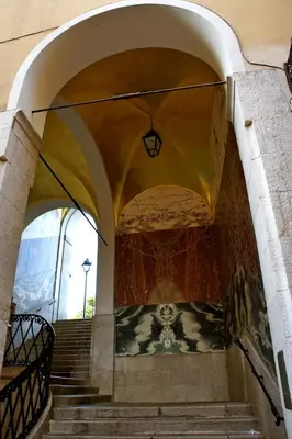 an archway with stairs in a building with a light at Old City Appartement of Nice in Nice
