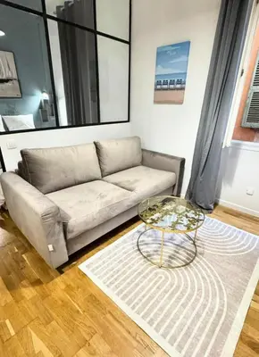 a living room with a couch and a table at Old City Appartement of Nice in Nice