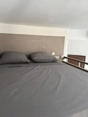a bed with two pillows on top of it at Appartement - Nice - Quartier du Port in Nice