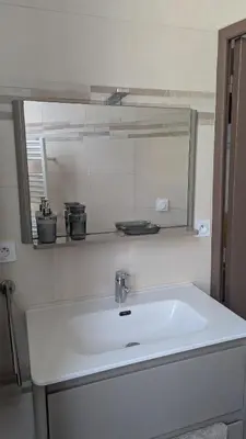 a white sink in a bathroom with a mirror at Appartement - Nice - Quartier du Port in Nice