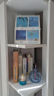 a book shelf with books and a plate of food at Appartement - Nice - Quartier du Port in Nice