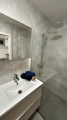 a bathroom with a white sink and a shower at Studio 4 Carré d'Or in Nice