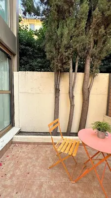 a orange chair and a table on a patio at Studio 4 Carré d'Or in Nice