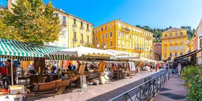a group of people walking around an outdoor market at Joli studio, quartier du port in Nice