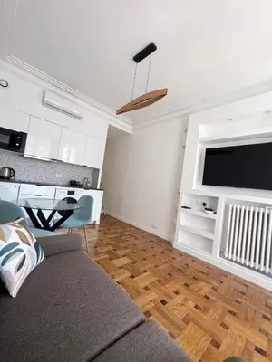 a living room with a couch and a flat screen tv at Appartement Rex in Nice