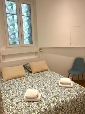 a bedroom with a bed with two towels on it at Appartement Rex in Nice