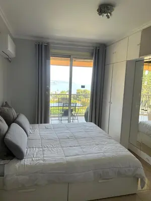 a bedroom with a bed and a view of the ocean at Elegant apartment a Nice, Sea View in Nice