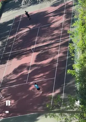two people riding skateboards on a tennis court at Elegant apartment a Nice, Sea View in Nice