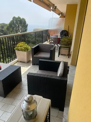 a patio with couches and chairs on a balcony at Elegant apartment a Nice, Sea View in Nice