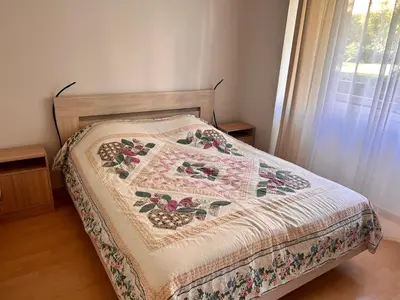 a bed in a bedroom with a quilt on it at Apparemment 2P centre Nice in Nice