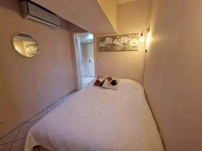 a kitchen and living room with a sink and a table at Le Centrale - Place Masséna in Nice