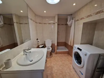 a bathroom with a sink and a washing machine at Le Centrale - Place Masséna in Nice