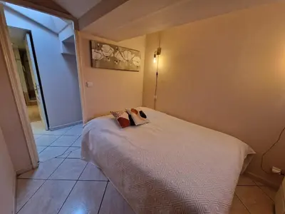 a small room with a bed with a mirror at Le Centrale - Place Masséna in Nice