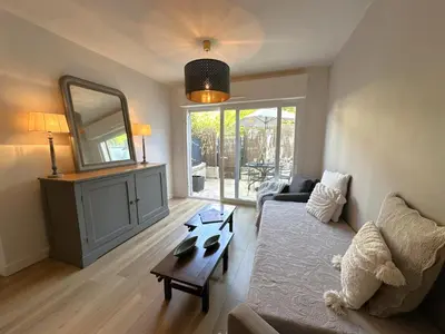 a living room with a couch and a mirror at Cocon Provençale à 5 min de la mer in Nice