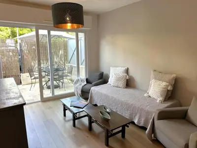 a living room with a couch and a table at Cocon Provençale à 5 min de la mer in Nice