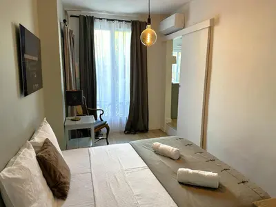 a bedroom with a bed with two towels on it at Cocon Provençale à 5 min de la mer in Nice