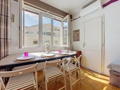 a dining room with a table and chairs and a window at Apartment Daphné by Interhome in Nice