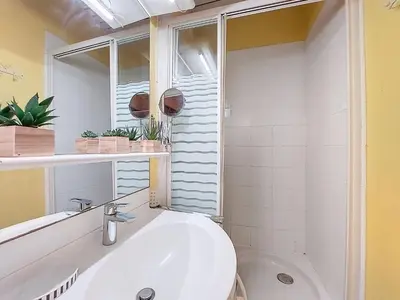 a bathroom with a white sink and a window at Apartment Daphné by Interhome in Nice
