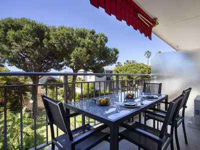 a table on the balcony of a house at Apartment Le Persépolis by Interhome in Cagnes-sur-Mer