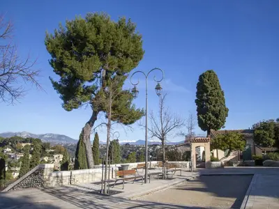 a park with benches and a street light at Apartment Le Persépolis by Interhome in Cagnes-sur-Mer