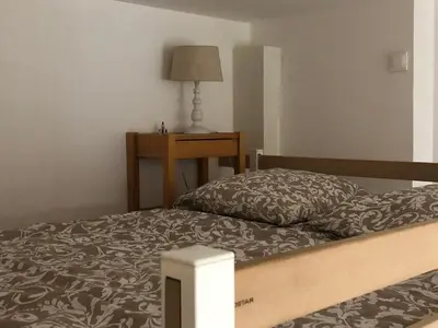 a bedroom with a bed and a table with a lamp at Agréable studio cœur de Nice in Nice