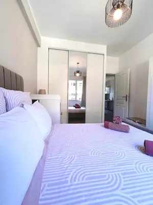 a bedroom with a large bed and a large mirror at Near Port & City - Private Parking & Breakfast - Full apartment in Nice