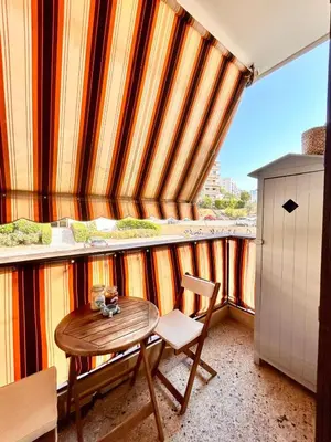 a table and chair in a room with a window at Near Port & City - Private Parking & Breakfast - Full apartment in Nice