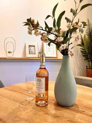 a bottle of whiskey and a vase on a table at Near Port & City - Private Parking & Breakfast - Full apartment in Nice