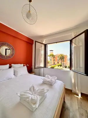 a bedroom with a large white bed with a window at Near Port & City - Private Parking & Breakfast - Full apartment in Nice
