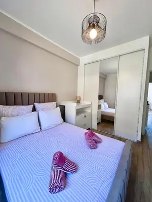 a bedroom with a bed with purple towels on it at Near Port & City - Private Parking & Breakfast - Full apartment in Nice