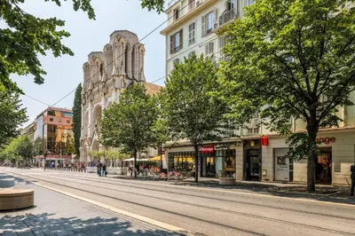 an empty street in a city with buildings at Elegant et lumineux 3 pieces Avenue Jean Medecin in Nice