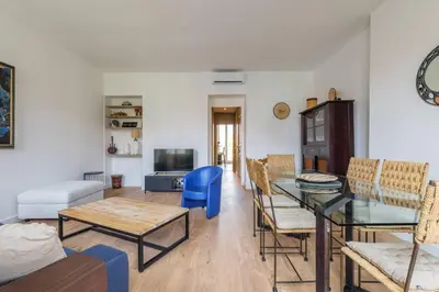 a living room with a dining room table and chairs at Elegant et lumineux 3 pieces Avenue Jean Medecin in Nice