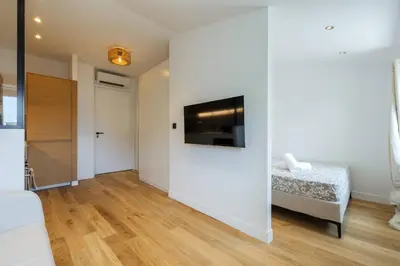 a bedroom with a bed and a tv on a wall at Magnifique studio boulevard Gambetta - B in Nice
