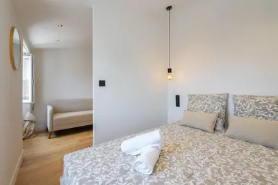 a white room with a bed with two pillows at Magnifique studio boulevard Gambetta - B in Nice