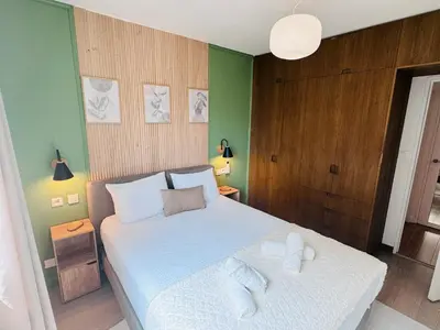 a bedroom with a bed with two towels on it at LE CARRAS - Proche de aéroport , Plage à pied - Promenade des anglais in Nice
