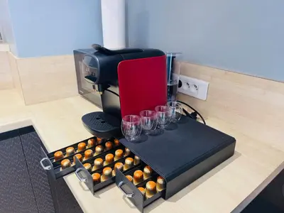 a counter with a coffee maker and a bunch of cups at LE CARRAS - Proche de aéroport , Plage à pied - Promenade des anglais in Nice