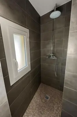a bathroom with a shower with a window at Rêve Bleu de Nice - Terrace - Beach & Tram 5 min in Nice