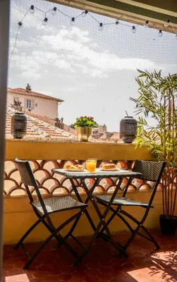 a table and chairs on a balcony with food on it at Rêve Bleu de Nice - Terrace - Beach & Tram 5 min in Nice