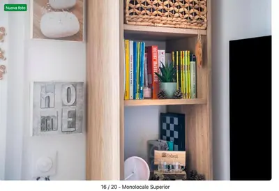 a book shelf filled with books in a room at The cozy corner of Amelie in Nice