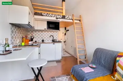 a small kitchen with a bunk bed in a small room at The cozy corner of Amelie in Nice