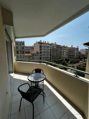 a balcony with a table and two chairs on it at Studio bord de plage à Nice in Nice