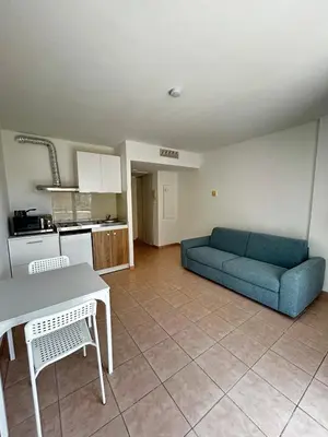 a living room with a couch and a table at Studio bord de plage à Nice in Nice