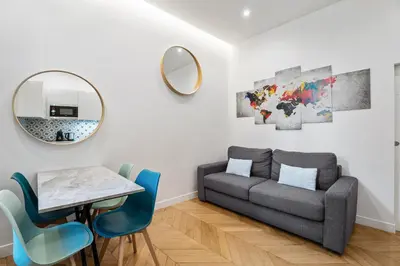 a living room with a couch and a table and a mirror at Nice Renting - VERDUN - Designer Cocoon Massena Calm Air Conditioning in Nice