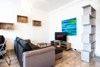 a living room with a couch and a tv at La Vague Douce in Nice