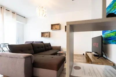 a living room with a couch and a tv at La Vague Douce in Nice