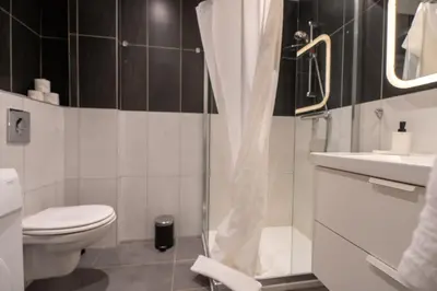 a bathroom with a shower and a toilet and a sink at La Vague Douce in Nice