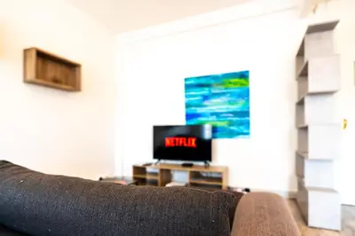 a couch sitting in a living room with a tv at La Vague Douce in Nice